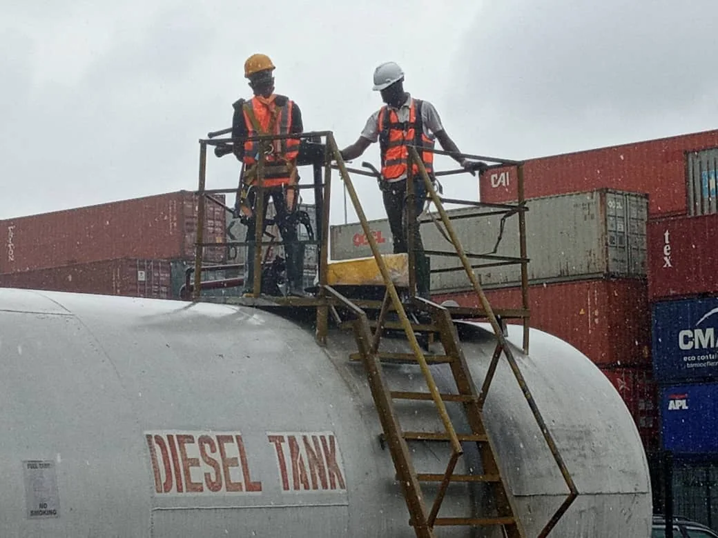 NOC technicians working on a storage tank
